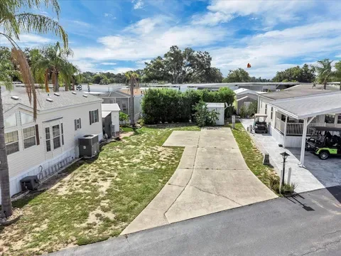 Cleared interior deeded RV lot with concrete pad and utility shed at 502 Par Pines Boulevard.